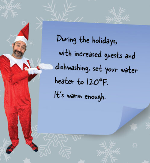 A person in a red Santa-style outfit and hat stands beside a curled blue sticky note with a tip to set the water heater to 120°F, against a snowflake background.
