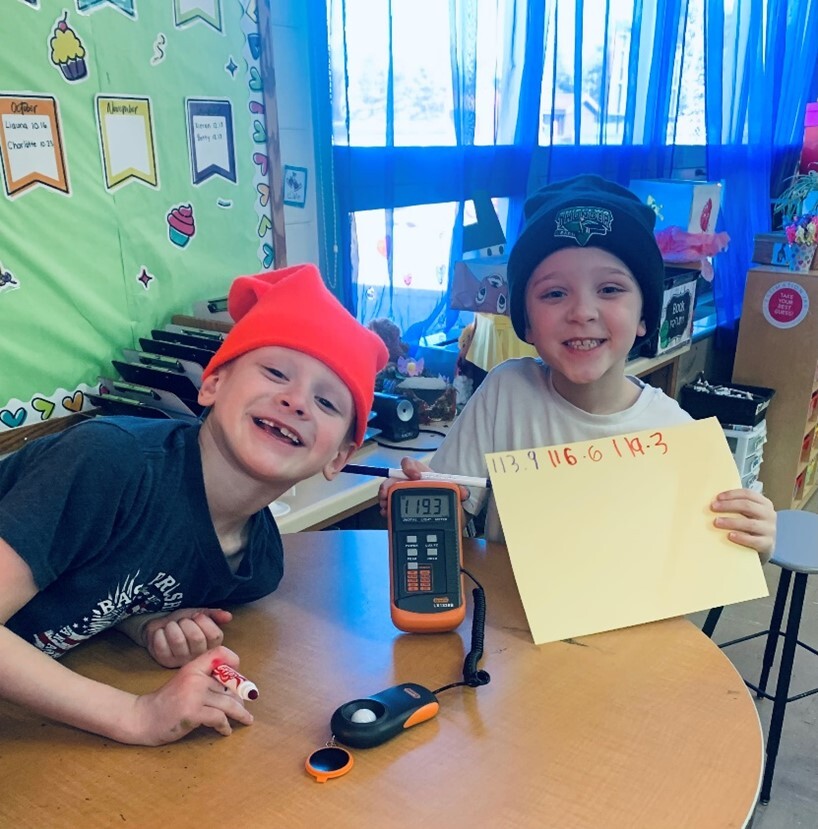 Two students showing an e-gauge and picture.