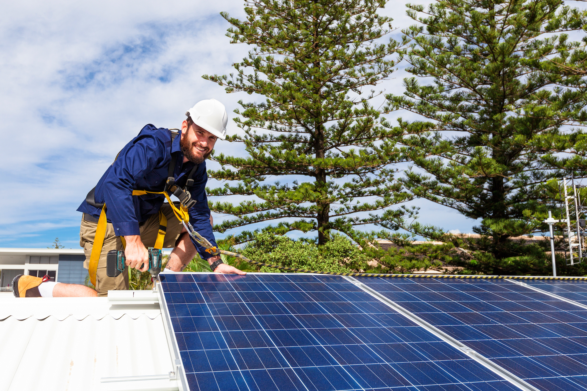 Man on Rooftop Installing Solar Panels