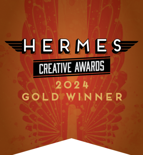Orange award badge featuring HERMES with wing accents, CREATIVE AWARDS banner, 2024 GOLD WINNER, and a black bottom notch.