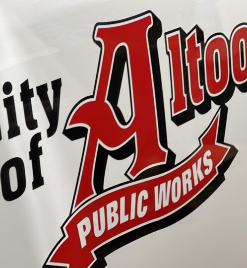 Logo on a white surface showing “City of Altoona” with a large red stylized A and a curved ribbon reading “Public Works.”