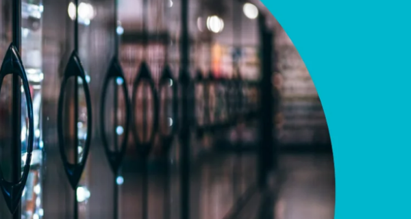 Teal brochure cover with a circular cutout showing refrigerated display cases; bold 'Commercial Refrigeration' headline and Focus on Energy logo bottom-right.